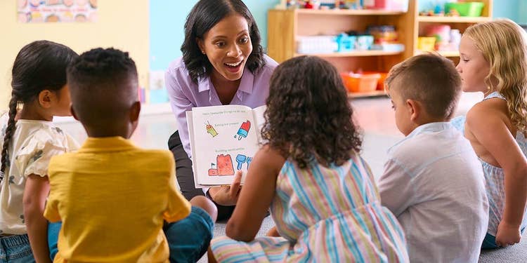 Teacher doing read aloud with students in classroom
