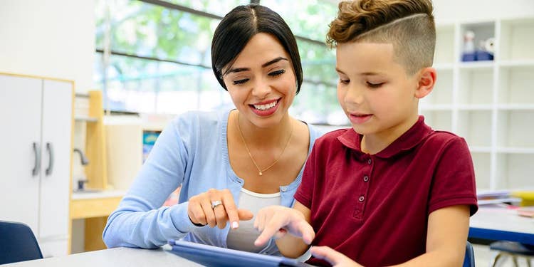 Teacher Helping a Child Learn